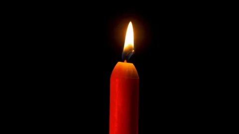 Tragic single Candle stable flame on black background Stock Footage 122862994