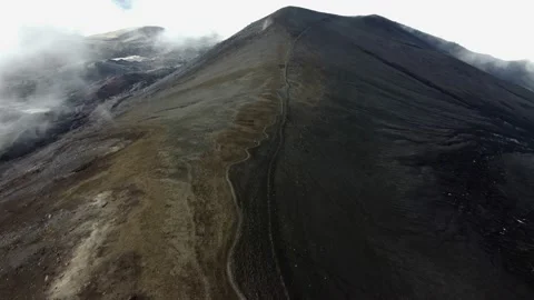 Trail on a black volcano in the clouds Vídeo Stock 167920804