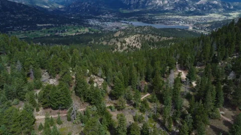 A trail cuts through the mountain peak near Lake Estes Colorado Stock Footage 247363762