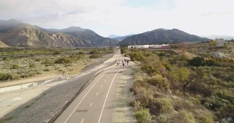 Trail cycling with mountain backdrop Stock Footage 77702710