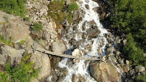 Trail to Glacier crossing a river, Swing Bridge, Norway Stock Footage 111568280