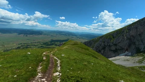 Trail leads to cliff edge with distant valley below. Savin Kuk peak, Montenegro Stock-Footage 342979625