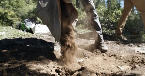 Trail maintenance crew dumping dirt onto hiking trail Stock Footage 97669911