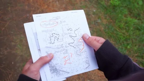 Trail map turning pages in the forest Stock Footage 157605288