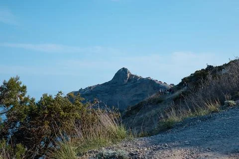 A trail in the middle of the mountains, a view of a mountain peak in the Stock Photos