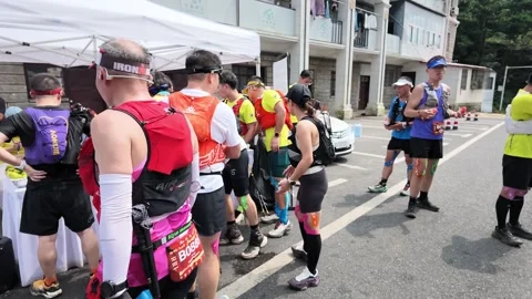 Trail Runner at Aid Station with Hydration Supplies, Lushan Race Stock-Footage 346717706