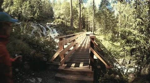 Trail runner in the alpine forest through the wood bridge. Stock Footage 53526589