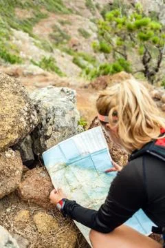 Trail runner checking map Stock Photos