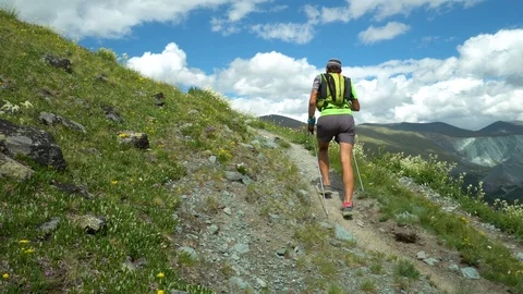 Trail runner climbing a stone trail to the mountain top. Stock Footage 121545223