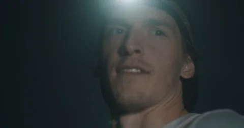 Trail runner with head light tired catching breath Stock Footage 98436193