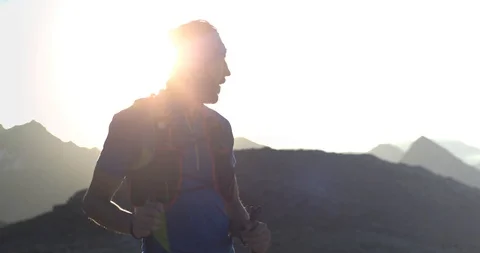 Trail runner man running reaching mountain top peak goal looking horizon view Видео 108320835