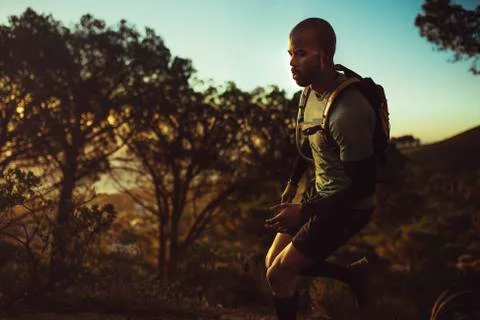 Trail runner practicing on mountain path Fotos Stock