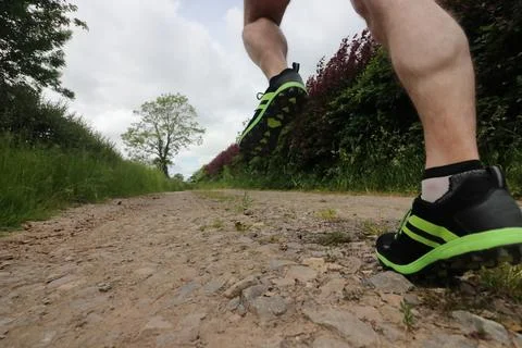 Trail runner running down a track Stock Photos