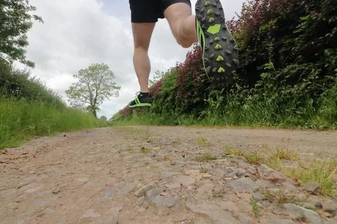 Trail runner running down a track Stock Photos