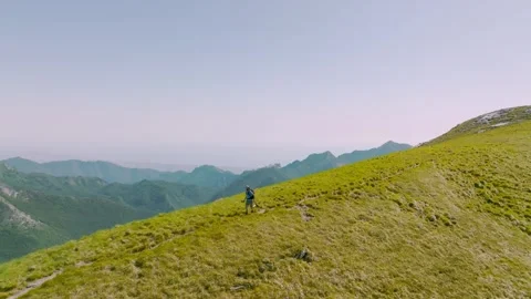 Trail runner running in the mountains, aerial view Stock Footage 270821113
