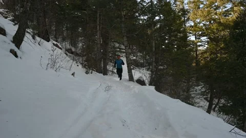 Trail Runner Running on Snow Packed Path Stock Footage 148238165
