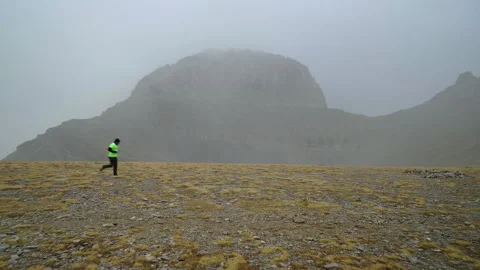 Trail Runner on Snowy Alpine Plateau with Throne of Zeus background, Mount Stock Footage 331958465