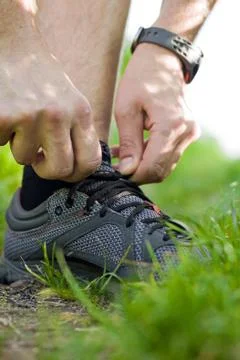 Trail runner tying shoe Stock Photos