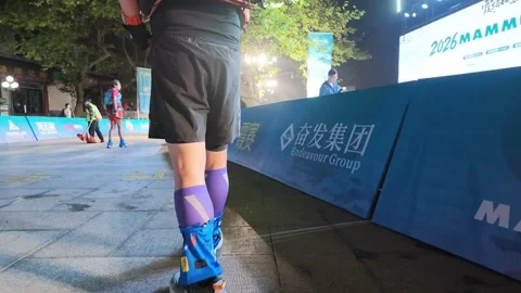 Trail Runner Walking to Start Line Behind Sponsor Barriers at Night, Lushan Stock Footage 346701100