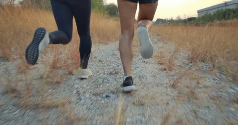 Trail Running in forest grass, Athlete fit two woman exercise runners Stock Footage 124422344