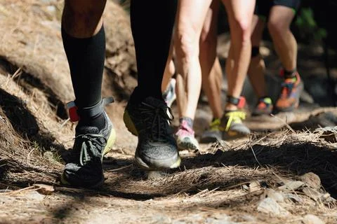 Trail running group on mountain path exercising Stock Photos