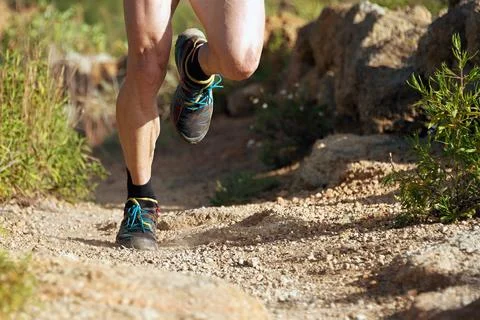Trail running man on mountain path Stock Photos