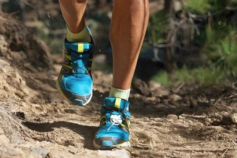 Trail running man on mountain path Stock Photos