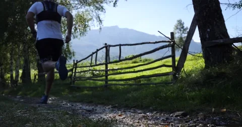Trail running man with the mountain ridge in the background. Running fast Stock Footage 139986401