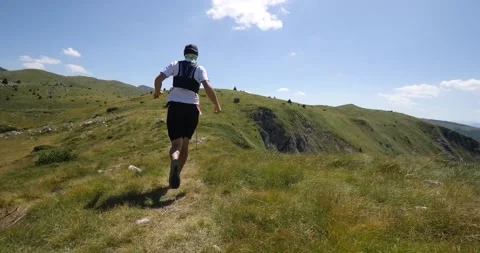 Trail running man on the ridge running in slow motion.  Stock Footage 139986648