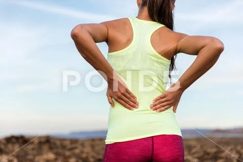 Trail running runner with lower back pain Stock Photos