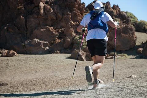 Trail running runner man on endurance run with hydratation trail vest Stock Photos