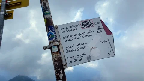 Trail sign marking Guli Pass in low angle above Svaneti Stock Footage 343773252