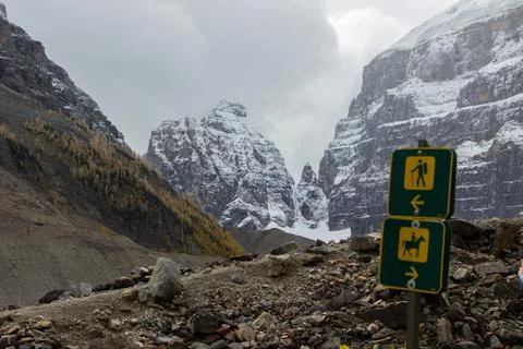 Trail sign that marks two paths, one path for hikers and another for horses. Stock Photos