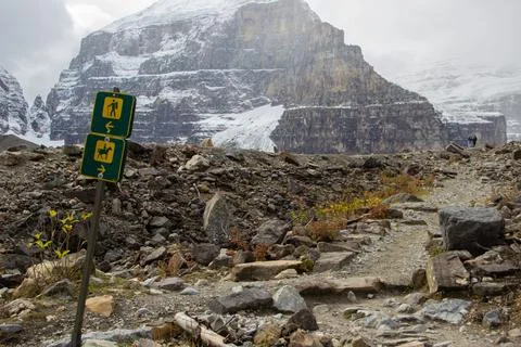 Trail sign that marks two paths, one path for hikers and another for horses. Stock Photos