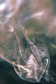 Trail of smoke on a dark background - creative colour effects with smoke smud Stock Photos