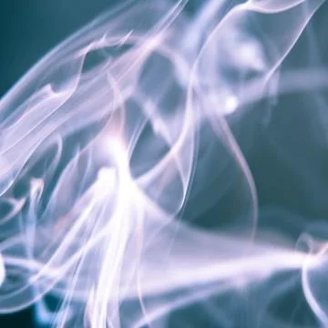 Trail of smoke on a dark background - creative colour effects with smoke smud Stock Photos