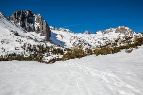 Trail through snow in the North Fork of Big Pine Creek headed toward Temple C Stock Photos