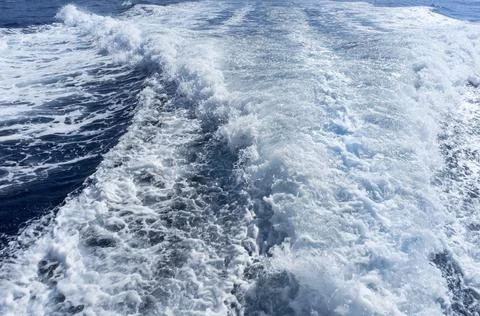 Trail on water surface behind of fast moving motor boat Stock Photos