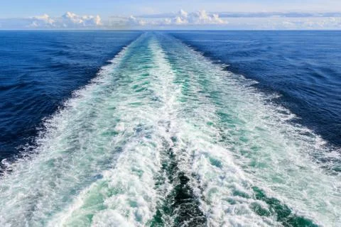 Trail on water surface behind the ferry Stock Photos