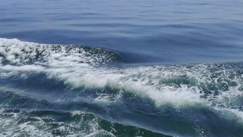 Trail on water surface on side of fast moving or sailing ship or boat Stock Footage 168568549