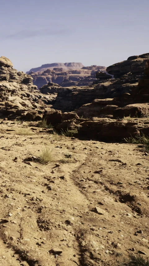 Trail winding through rocky landscape in the desert with mountain views Video stock 331753496