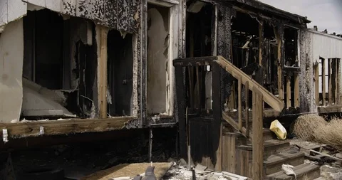 Trailer Home Back Burnt Out Wide Shot Crash Zoom in to Gas Can Stock Footage 89941696