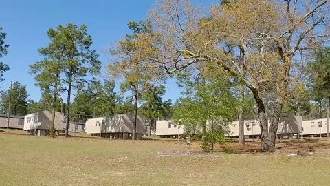 Trailer park mobile home park community broken down red truck Stock Footage 172422868