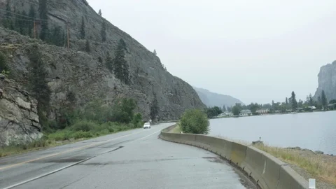 A trailer passes by the side of the lake Stock Footage 99996979