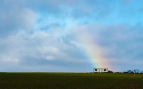 The trailer with a rainbow on a field Stock Photos