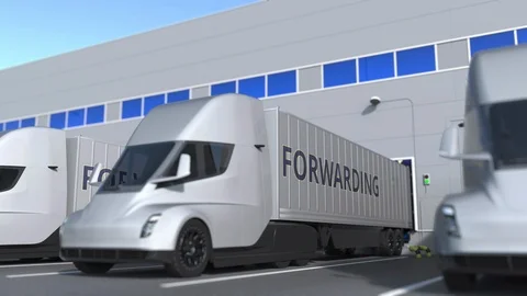 Trailer trucks with FORWARDING text being loaded or unloaded at warehouse Stock Footage 124892000