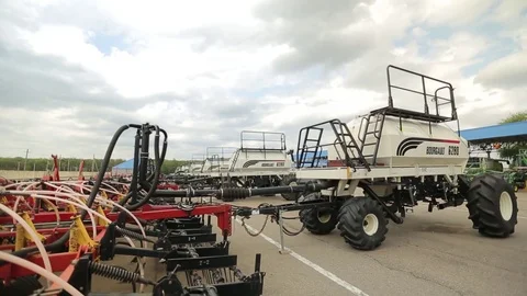 Trailers for harvesters plows are parked for agricultural machinery Stock Footage 73946700
