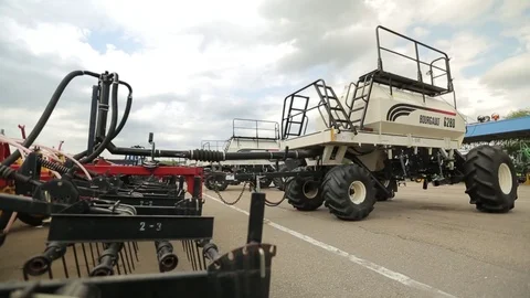Trailers for harvesters plows are parked for agricultural machinery Stock Footage 82296034