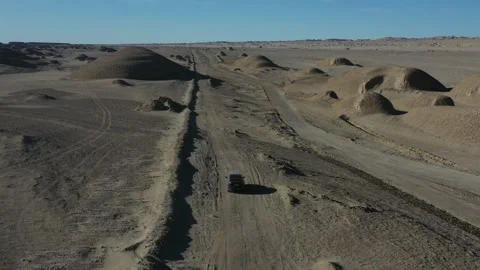 Trailing an EV through the Desert and Giant Dome Landforms in West China Stock Footage 205157387