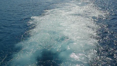 Trailing seaway full of boiling splashes and bubbles after a large ship in slo Video stock 101272825